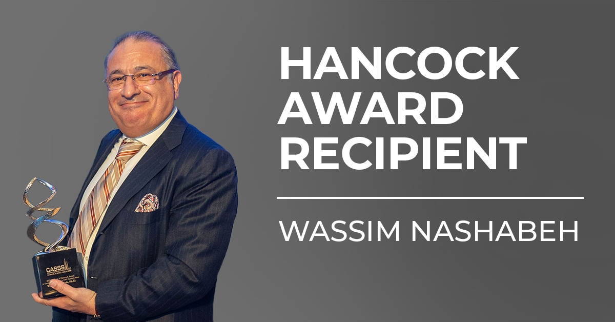 Male holding a gold award with text 'Hancock Award Recipient Wassim Nashabeh'