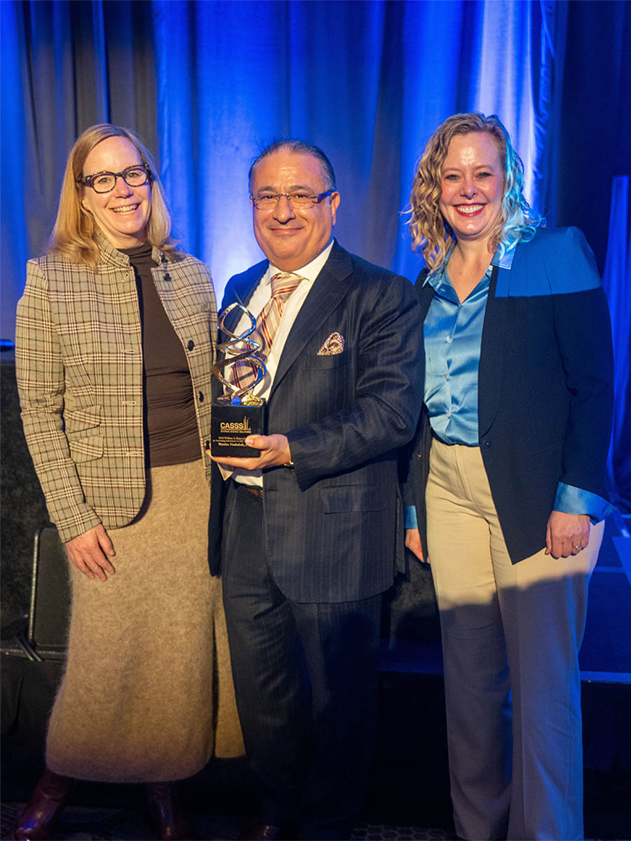 Two females and one male presenting Hancock Award at WCBP 2024.