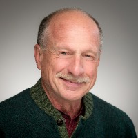 Image of professional headshot of a man in front of a gray background