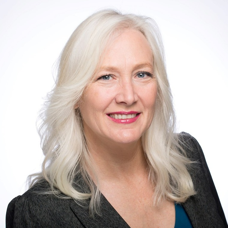 Image of female with white hair in business suit.